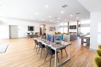 a living room with a dining room table and a couch at Centennial Crossing, Waukee, 50263